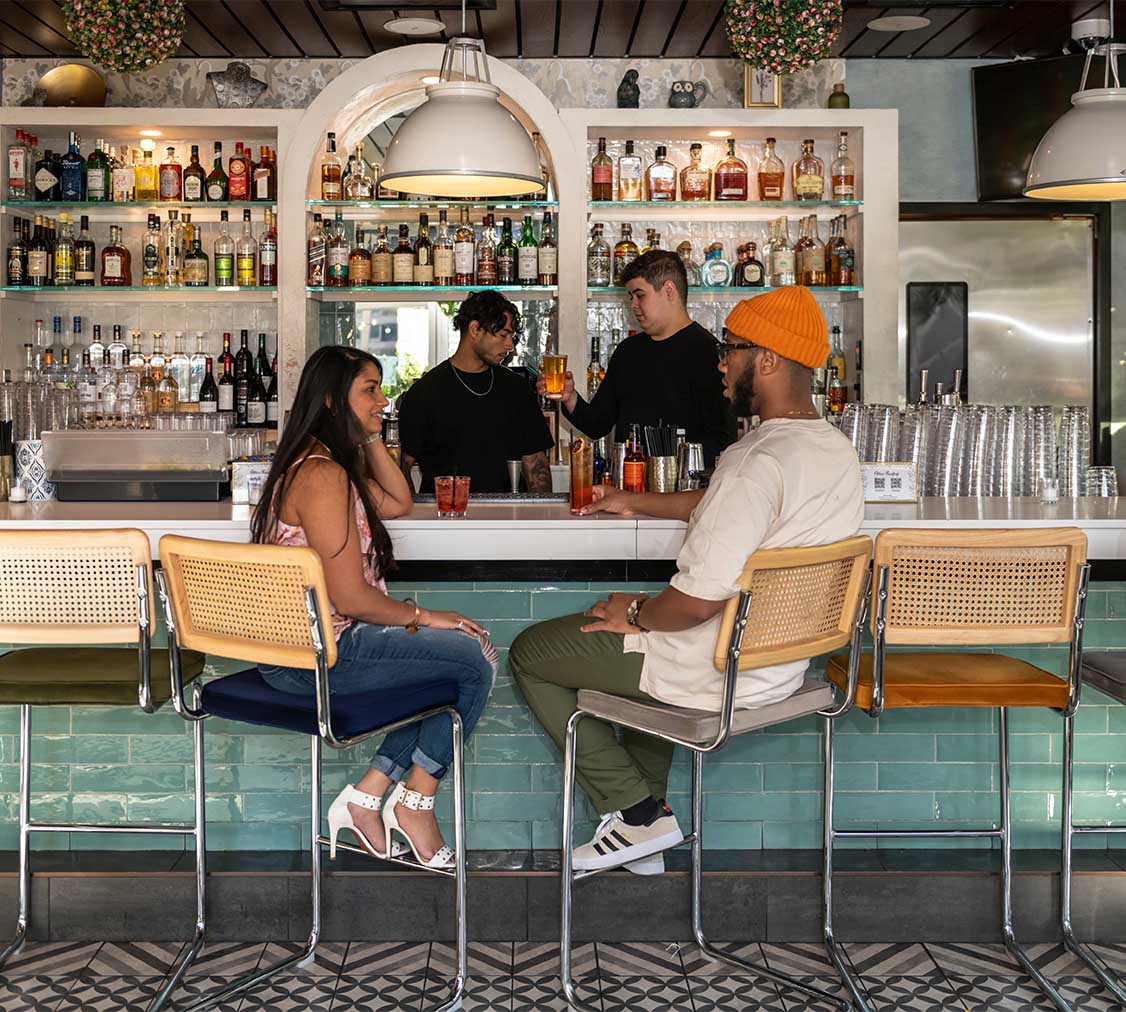 People drinking together in eclectic bar.