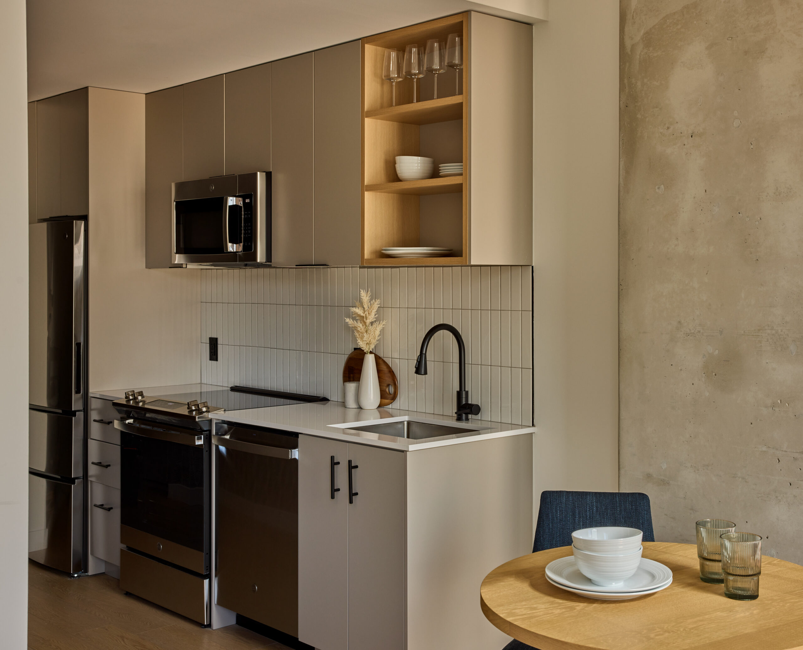 Gallery kitchen with stainless steel appliances and stylish backsplash