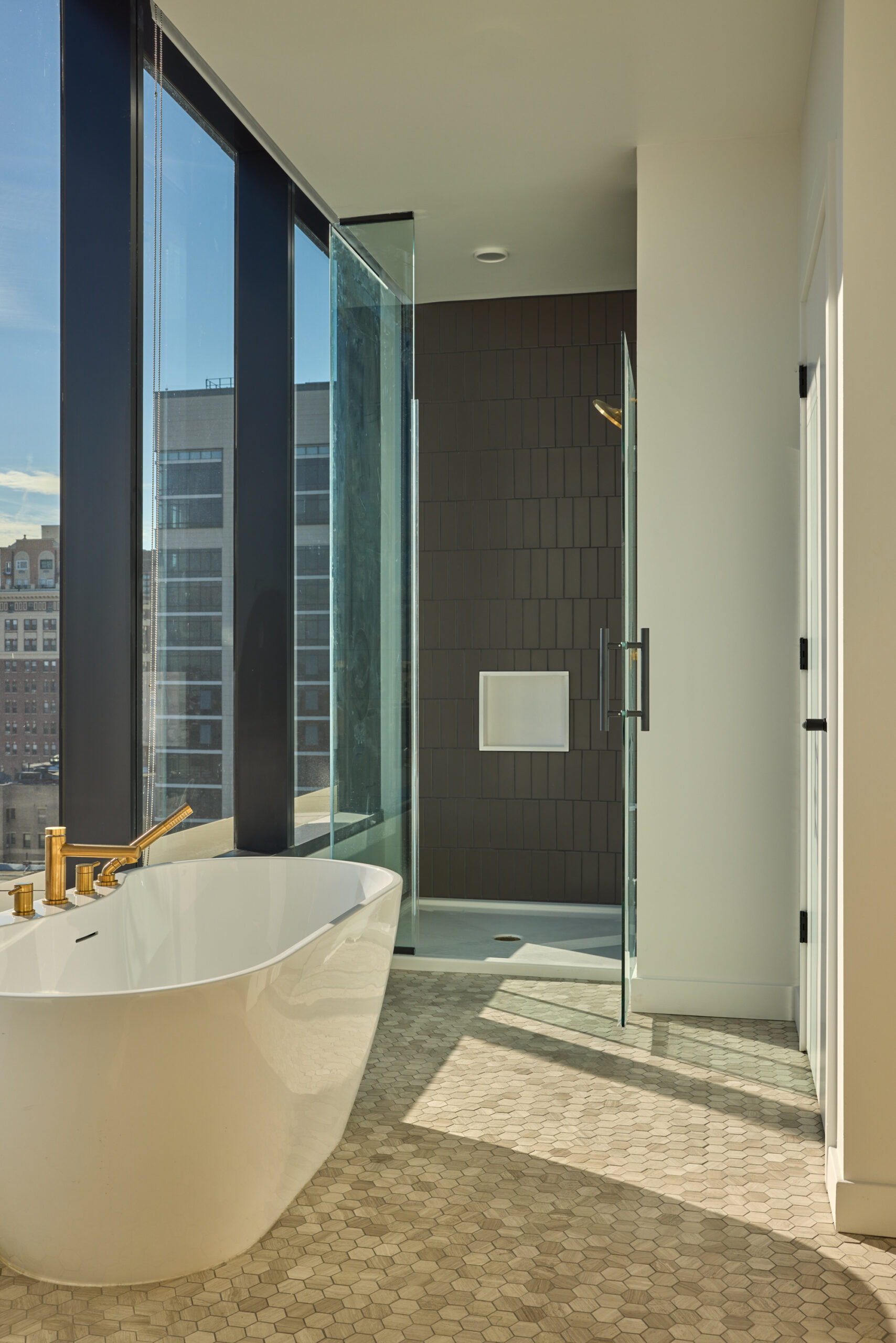 Penthouse bathroom with stylish tile flooring and soaking tub.