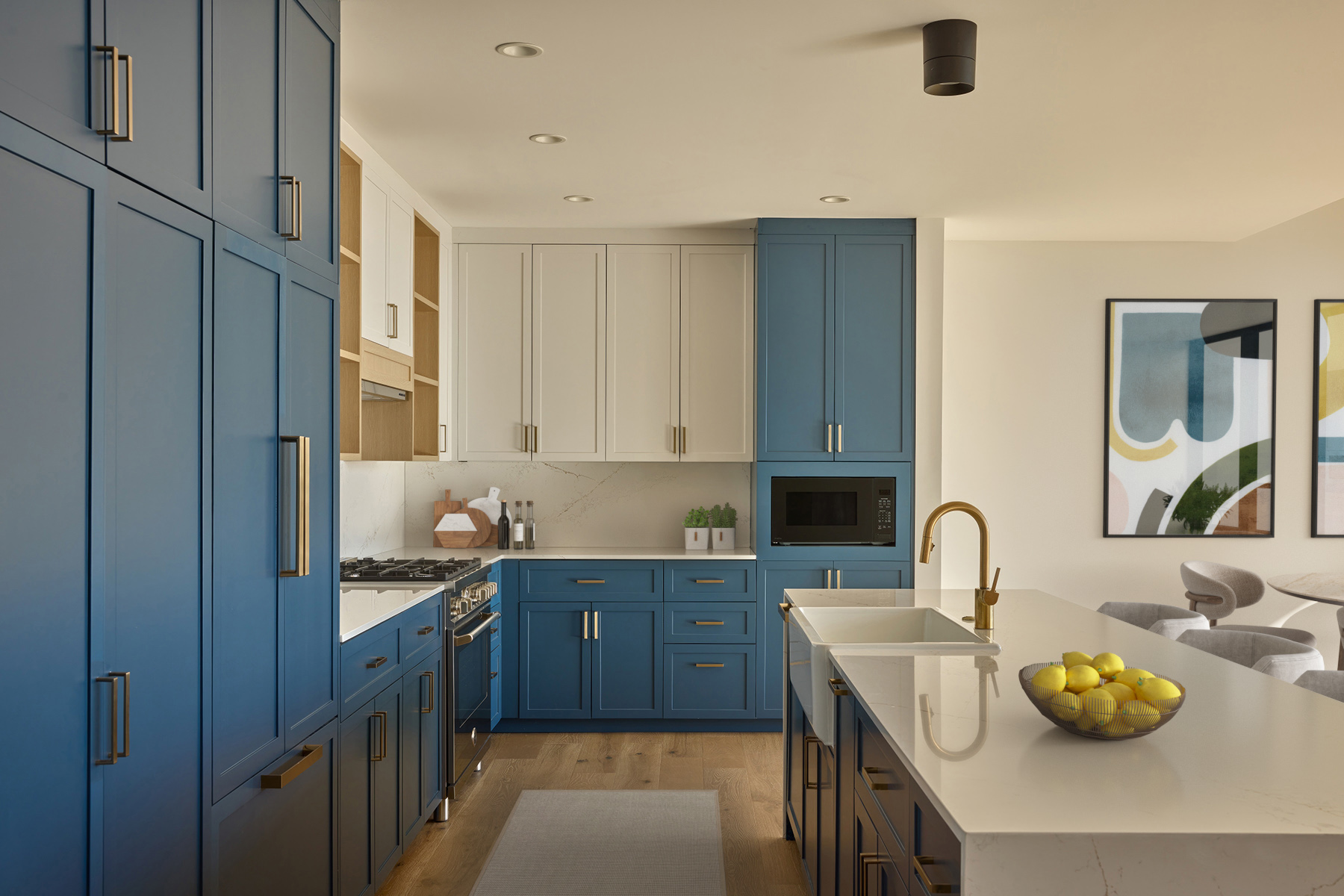 Penthouse kitchen with plenty of dual-toned stylish cabinetry and island for extra counterspace